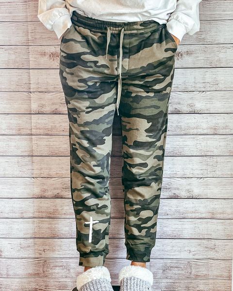 a person wearing a pair of camouflage sweatpants